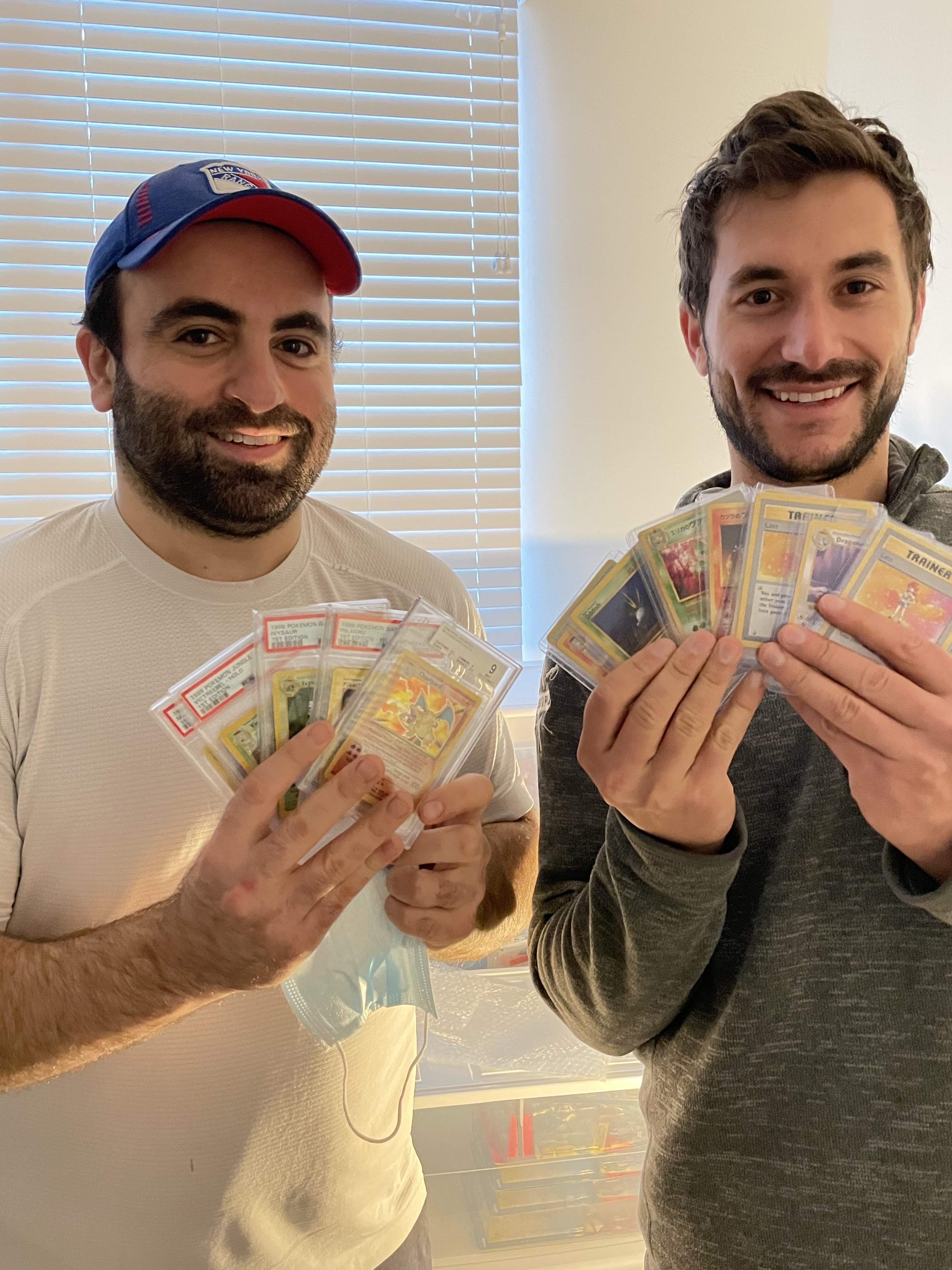 Will and Elliot holding their Pokémon card collection